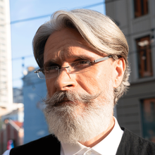Load image into Gallery viewer, Male Model wearing Gels® Slim Rectangle Rubber Coated Readers in Black readers by Scojo New York®. Purchase them at ReadingGlasses.CO