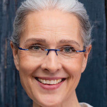 Load image into Gallery viewer, Female Model leaning against a barn wearing Gels reading glasses Cobalt color 735