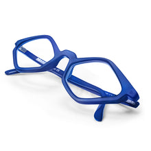 Load image into Gallery viewer, Table view of Edgy Matte Blue Cat Eye reading glasses photographed on a white background. Designed and made by Nannini of Italy. Buy them at ReadingGlasses.CO/