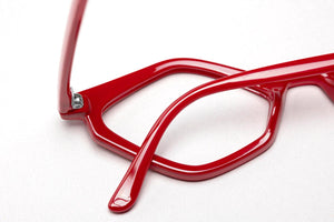 Abstract view of Edgy cat eye in glossy red reading glasses photographed on a white background. Designed and made by Nannini of Italy. Buy them at ReadingGlasses.CO/