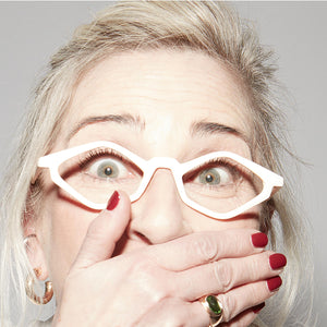 Female model looking surprised while wearing Nannini edgy reading glasses. Buy Edgy at ReadingGlasses.CO/