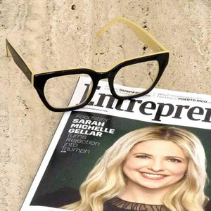 Moon Rocks Optical Reading Glasses with a copy of Entrepreneur magazine, eyewear in black and creme; by Aj Morgan. Buy the readers at ReadingGlasses.CO/
